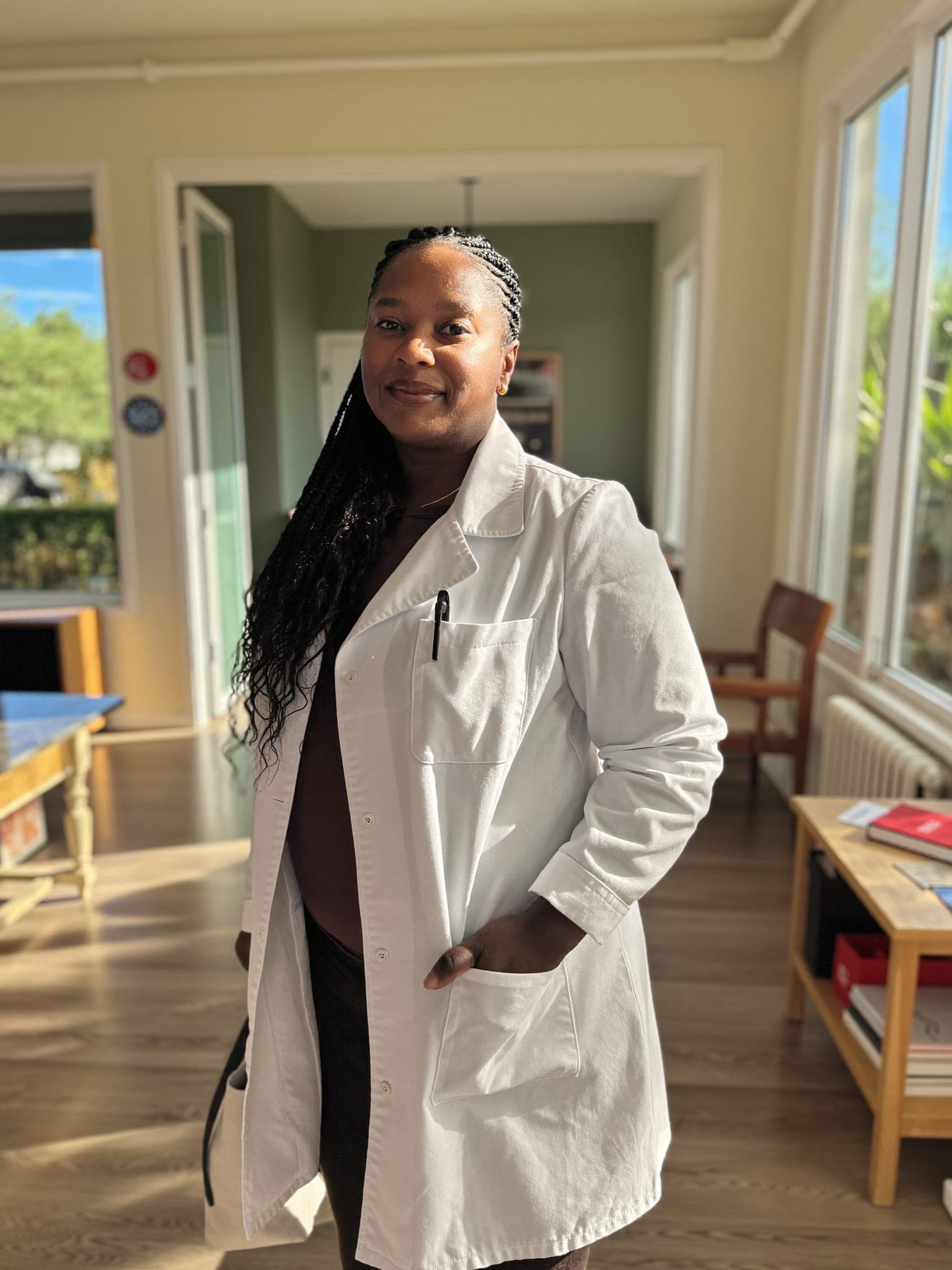 A doctor at a modern private clinic in Lusaka, unhurried and in control of her schedule